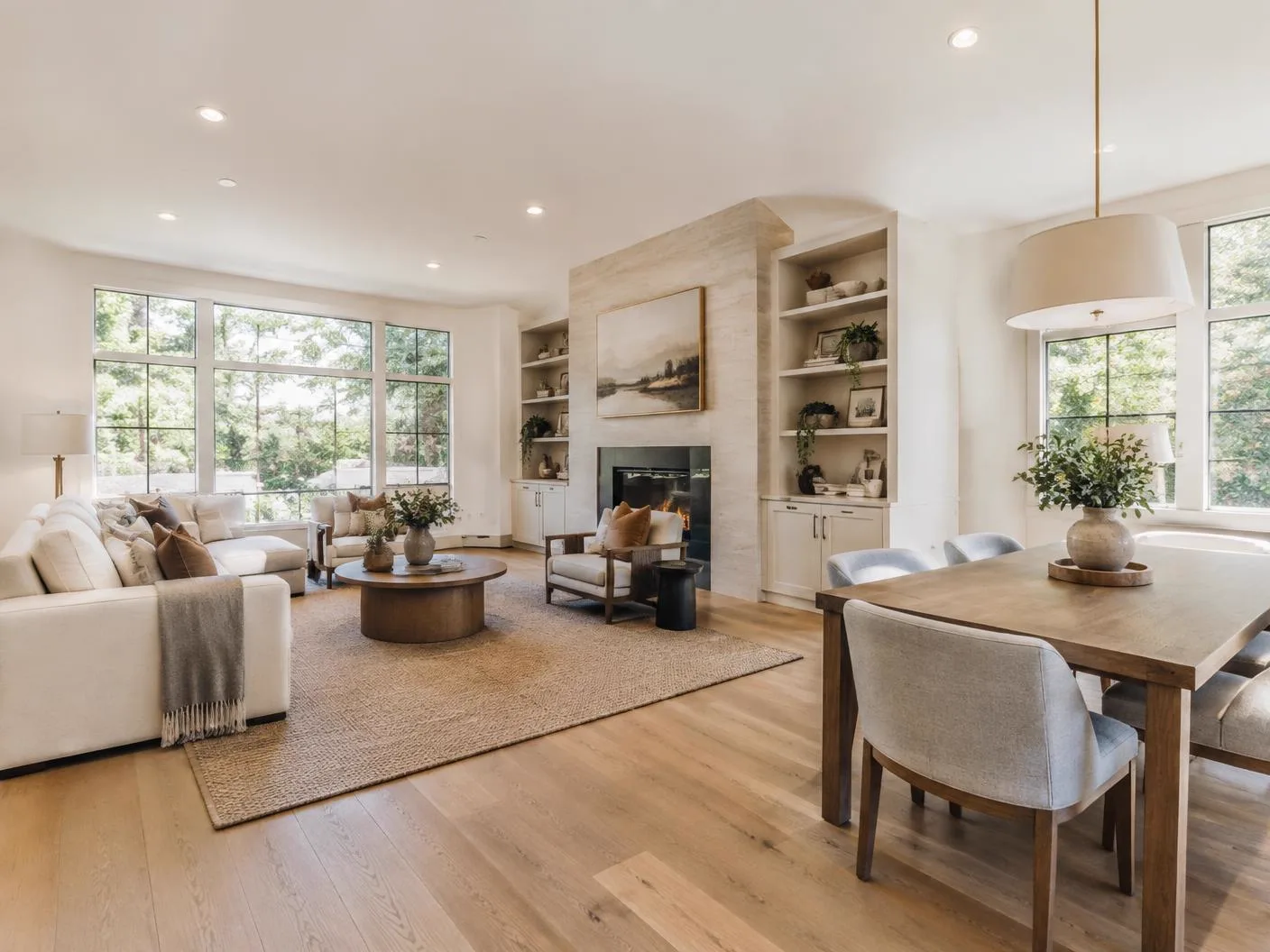 Remodeled open-concept living and dining space with wood floors and large windows