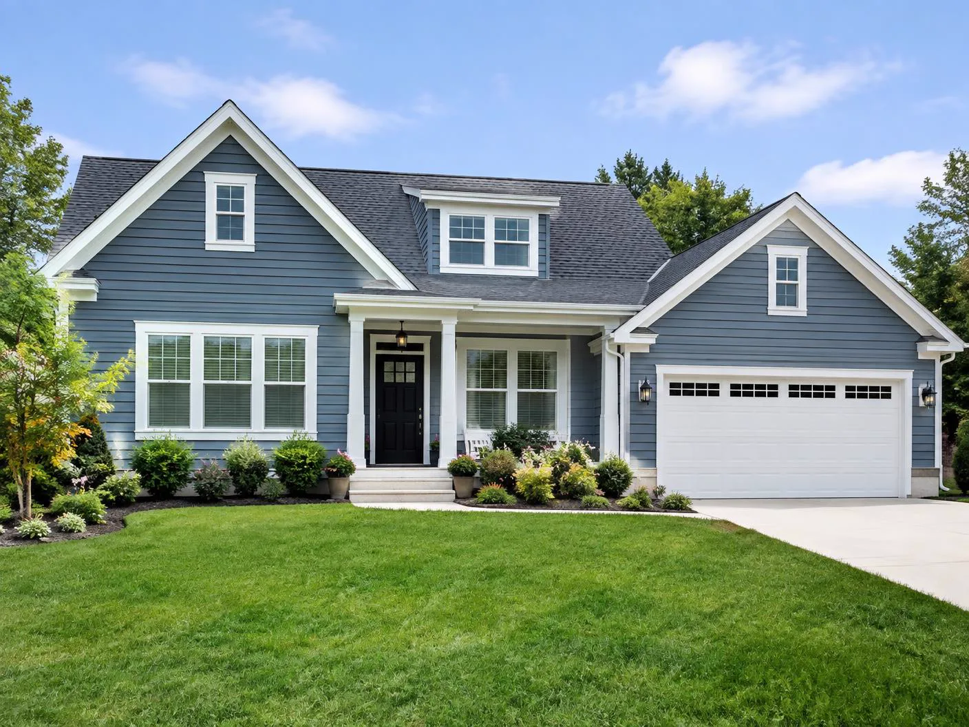 Freshly painted blue residential home exterior with white trim