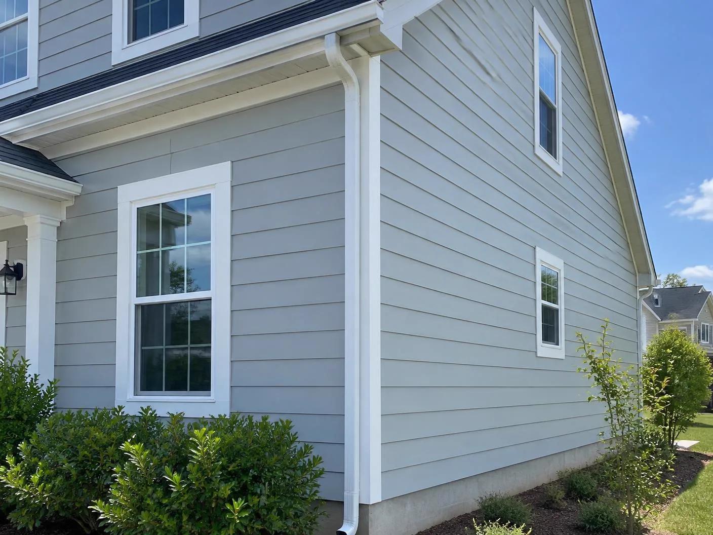 Home exterior with light gray horizontal lap siding and white trim